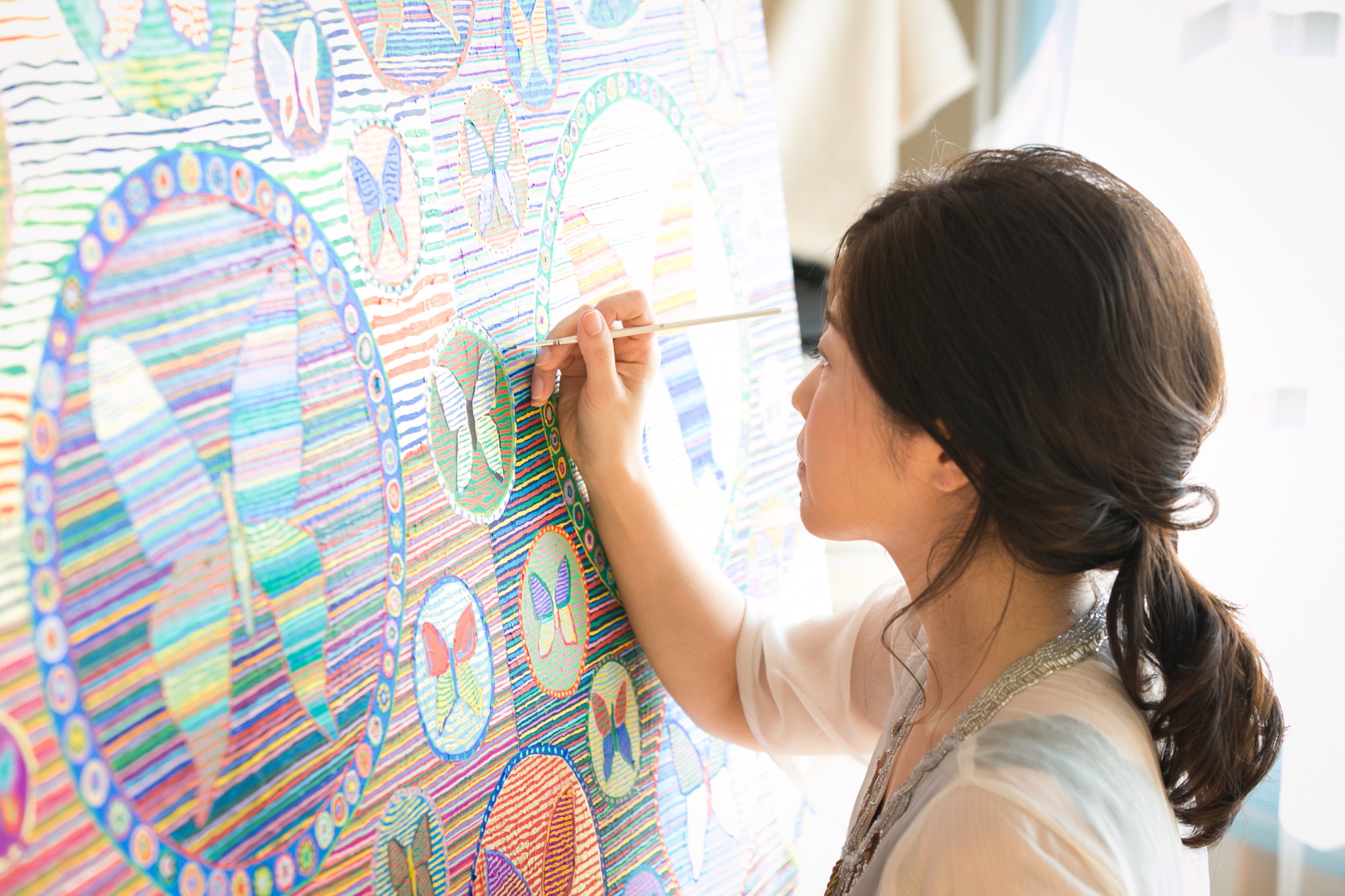 Minami Fukasaka, also known as Michiko Kawachi, creating an artwork